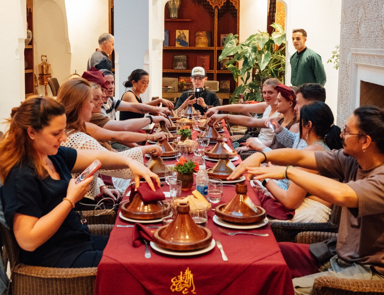 A group of friends on a group tour with TruTravels prepare to see their final dishes from the local cooking class that they have just taken