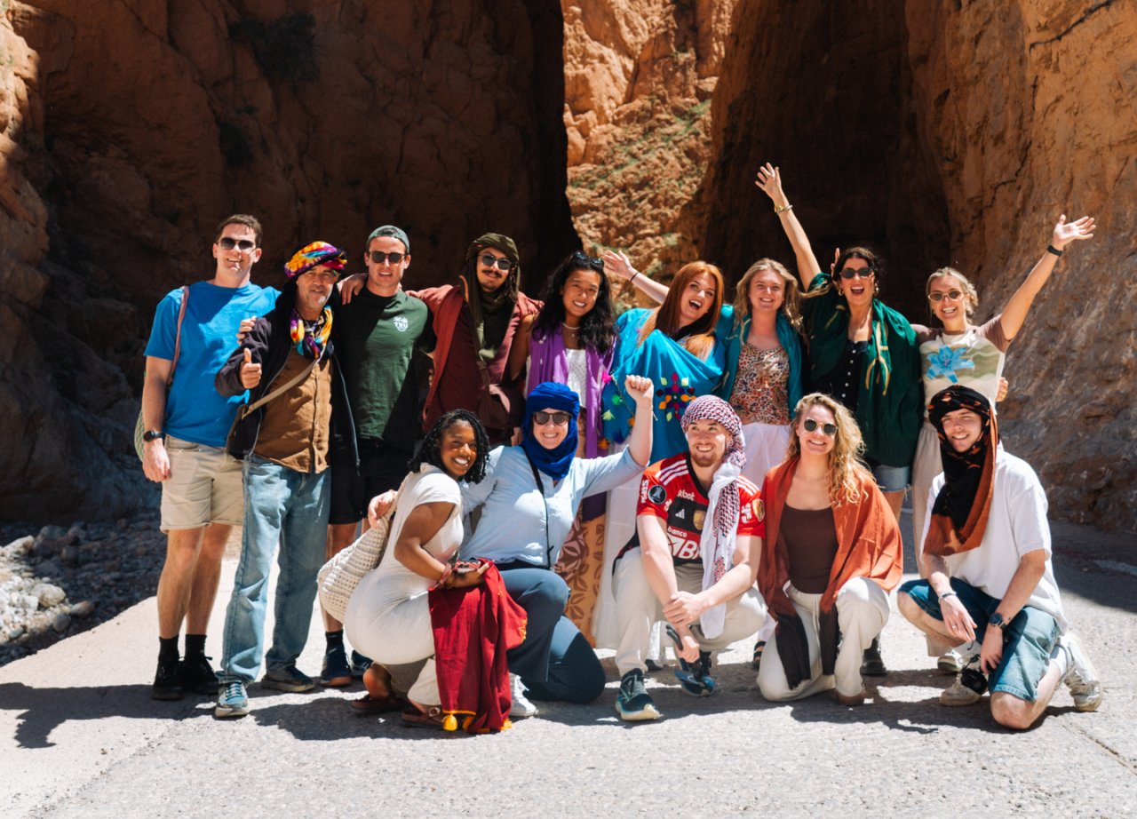 A group of solo travellers in front of Todra Gorge in Morocco